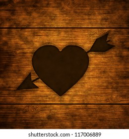 Burnt Wood Background With Branded Love Heart And Arrow