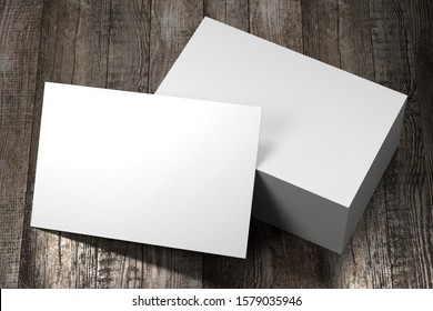 Business card (55x85mm) mockup, wooden background - 3D rendering