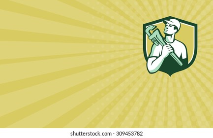 Business card showingillustration of a tradesman plumber holding adjustable monkey wrench on shoulder looking up to the side set inside shield crest on isolated background done in retro style.  - Powered by Shutterstock