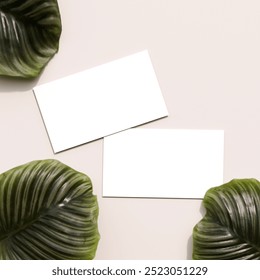 Business cards placed on a tropical leafy background, suitable for nature-themed or eco-friendly branding projects.  - Powered by Shutterstock