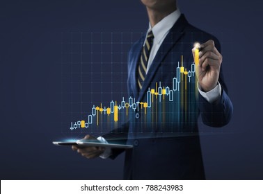 Business growth, progress or success concept. Businessman is drawing a growing virtual hologram stock on dark tone background. - Powered by Shutterstock