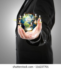 Business man holding the small world in his hands against white background (Elements of this image furnished by NASA)