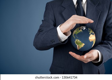 Business Man Protecting The Earth. Sustainable Responsible Business, Eco-friendly Business, Global Business Concepts. Move Heaven And Earth Idiom.