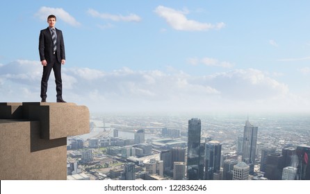 Business Man Standing High Over A Cityscape