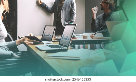 Business meeting with laptops, and graphs. Diverse team discussing data. Diverse business professionals in strategic meeting. Diverse team in global business connection strategy planning. - Powered by Shutterstock