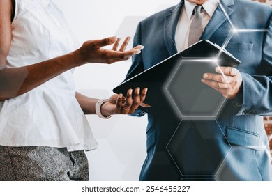 Business meeting with two diverse professionals discussing documents. Male and female professionals in business deal. Professionals collaborating in a business meeting with modern graphic.  - Powered by Shutterstock