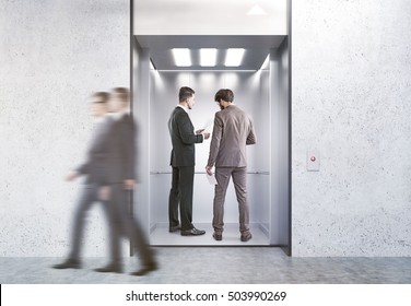 Business People In Open Elevator In Modern Office. Concept Of Working In High Building. 3d Rendering. Mock Up