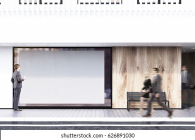 Business People Are Passing By A Shop Window With A Large Horizontal Poster, A Bench And A White Balcony On The Second Floor. Concept Of Promotion. 3d Rendering, Mock Up