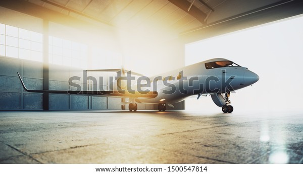 Business private jet airplane\
parked at maintenance hangar and ready for take off. Luxury tourism\
and business travel transportation concept. 3d\
rendering
