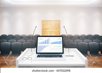 Business Report On Laptop Screen Placed On Speaker's Stand In Conference Hall Interior With Rows Of Seats And Wooden Door. 3D Rendering