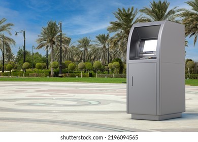 Business Technology Concept. ATM Deposit Machine On An Empty City Street With Palm Trees Extreme Closeup. 3d Rendering