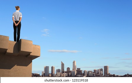 Business Woman Standing High Over A Cityscape