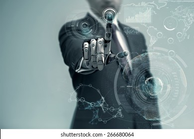 Businessman With Artificial Robotic Hand Working On Virtual Holographic Interface. Future Technology As Design Concept.