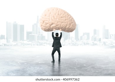 Businessman Holding Brain With Foggy City In The Background, 3D Rendering