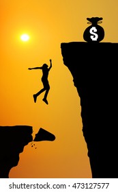 Businessman Jump Through The Barbwire For Money. , Man Jumping Over Cliff On Sunset Background,Business Concept Idea