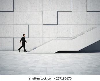 Businessman moving forward and up the stairs