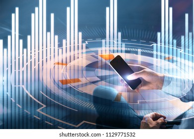 businessman sitting with smartphone at digital cyber button and financial chart background - Shutterstock ID 1129771532