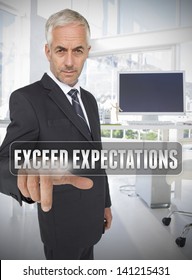 Businessman Touching The Term Exceed Expectations In His Office