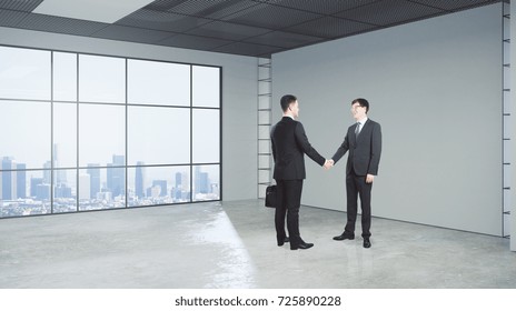 Businessmen shaking hands in modern concrete office with city view. Teamwork concept. Double exposure 