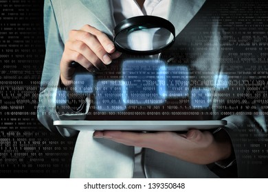 Businesswoman with magnifier glass examining binary code - Powered by Shutterstock