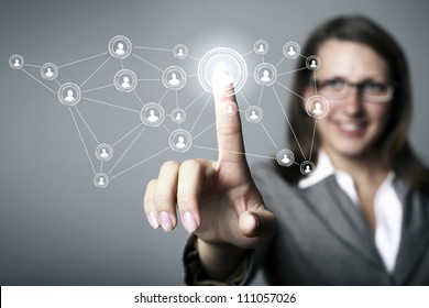 Businesswoman in suit pressing social media icon - Powered by Shutterstock