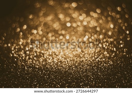 A captivating image featuring a multitude of golden bokeh lights scattered across a dark background, creating a sense of depth and warmth.