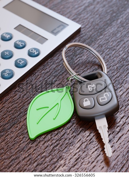 Car loan calculation concept with car keys and\
green leaf keychain
