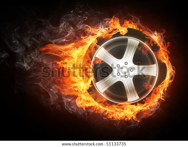 Car\
wheel in fire flames isolated on black background.\
