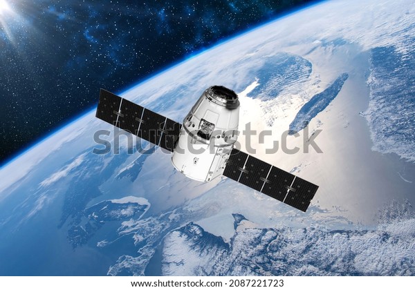 Cargo space craft Earth planet. Dark\
background.Sci-fi wallpaper.Space Station Orbiting Earth.Space\
ship.Space art wallpaper.Solar Observatory.Elements of this image\
furnished by NASA.3d\
illustration
