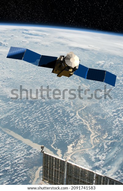 Cargo space craft and Earth planet. Dark 3D\
illustration.. Sci-fi wallpaper.Space Station Orbiting Earth.Space\
ship. Space art wallpaper.Solar Observatory.Elements of this image\
furnished by NASA