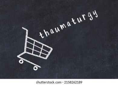 Chalk Drawing Of Shopping Cart And Word Thaumaturgy On Black Chalboard. Concept Of Globalization And Mass Consuming.