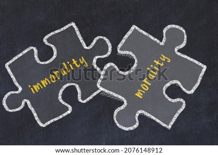 Chalk drawing of two puzzles with words immorality and morality. Concept of solving problems