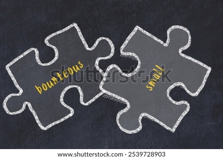 Chalk drawing of two puzzles with words bounteous and small. Concept of solving problems
