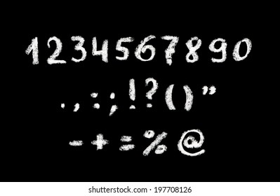 Chalk Hand Written Numbers And Punctuation Marks On Black Board