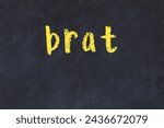 Chalk handwritten inscription brat on black desk