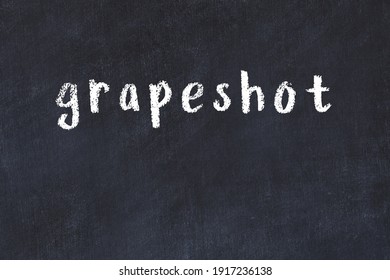 Chalk Handwritten Inscription Grapeshot On Black Desk