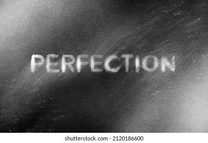 Chalkboard illustration, hand written text in chalk on a black board about perfection and perfectionism, writing that’s ironically imperfect and flawed