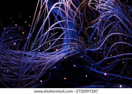Chaotic yet beautiful 3D render of data streams. Glowing points of light represent information packets moving through a complex web of interconnected fiber lines