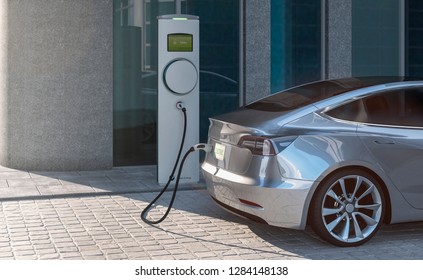 Charging An EV Electric Sedan Car With Silver Paint In A City Parking Lot 3d Illustration