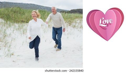 Cheerful senior couple running at beach against love heart - Powered by Shutterstock