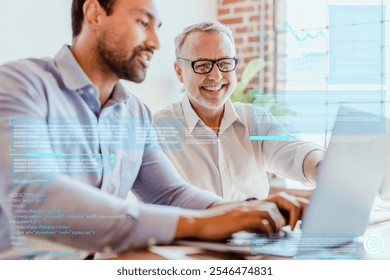 Cheerful web developers working on laptop. Diverse business partners planning on laptop. Indian and caucasian man working together on a laptop. Business team and partnership. Web development concept. - Powered by Shutterstock