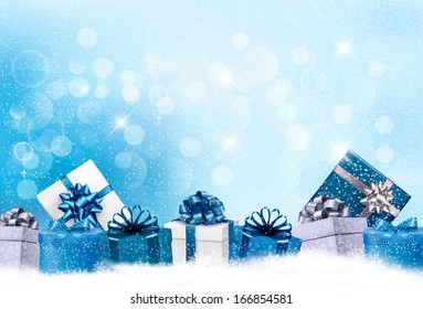 Christmas Blue Background With Gift Boxes And Snowflakes. Raster Version