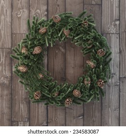 Christmas decorative wreath with cones on wood