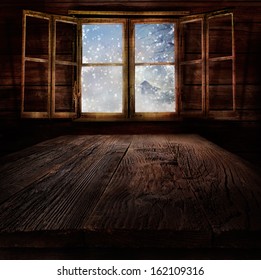 Christmas Design - Snowing. Xmas Winter Background In Wooden Cabin With Snowing Nature  And Winter Landscape In The Back.