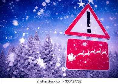 Christmas Road Sign Against Snowy Landscape With Fir Trees