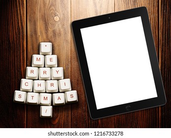 Christmas tree made of computer keys and tablet computer on wooden background . 3d rendering