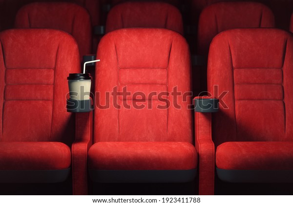 Cinema\
movie theater concept background. Red cinema seats and coffee or\
cola paper cup in empty theater. 3d\
illustration