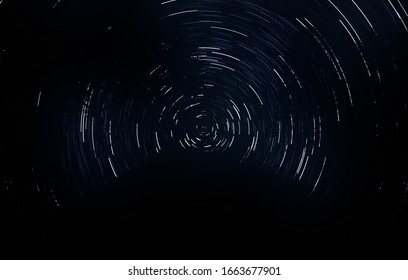 Circular light paths. Starry background. Dark heavens. Beautiful lines. Radial motion. Trails. Clear sky. Time lapse. 2d illustration. Stars at night. Long exposure.