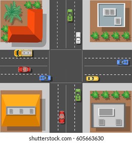City intersection with the rooftops view from above with cars and trees
