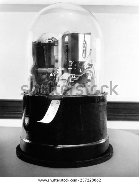 Classic 1920\'s stock ticker with a glass dome Stock\
tickers were specialized telegraphs that conveying stock prices\
Ca.